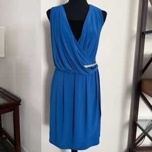 sleeveless blue draped dress with a gold-tone belt detail.